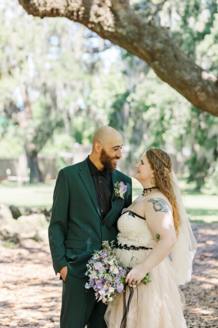 couple exchanging vows at tree of life in new Orleans