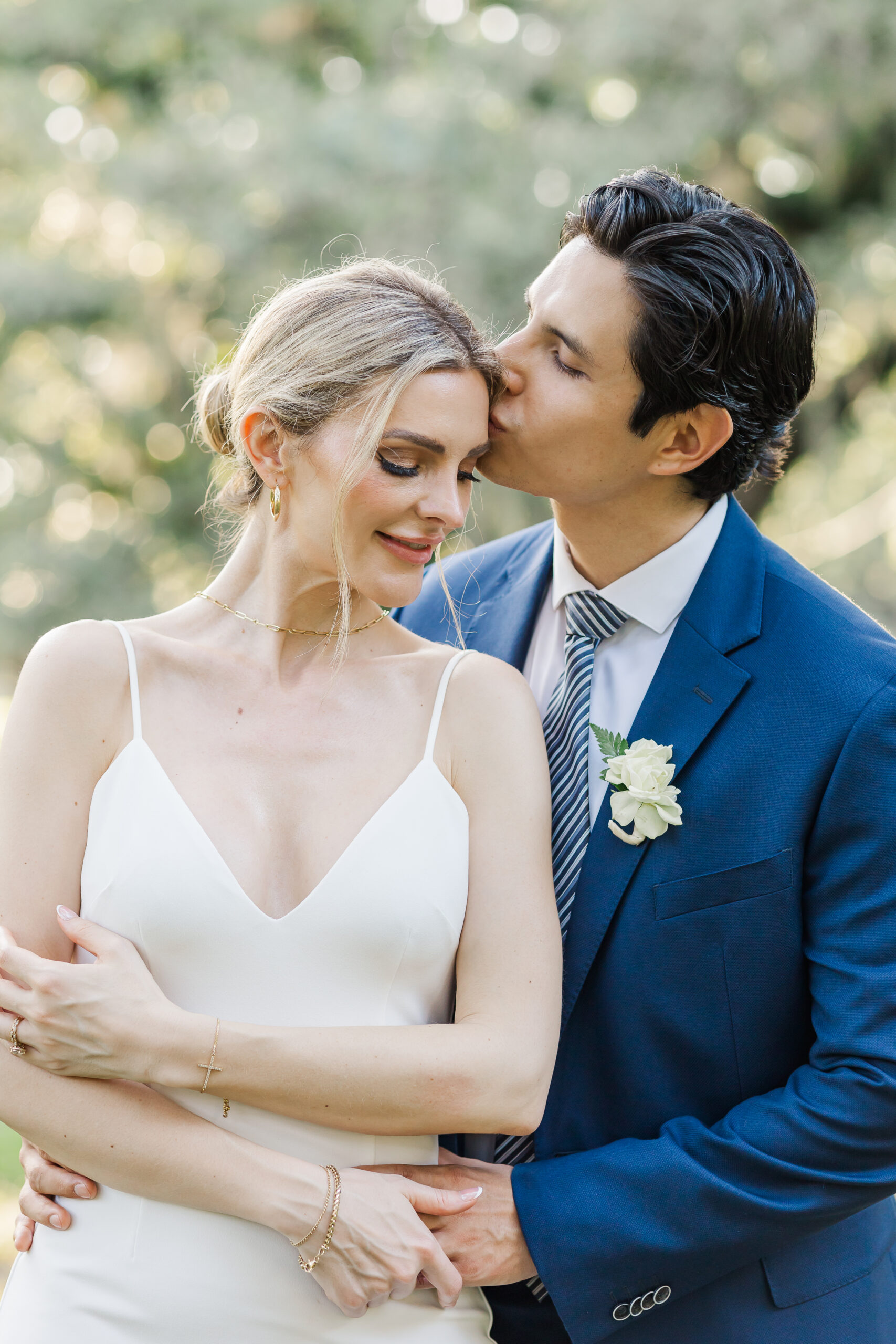 couple sharing an intimate moment after elopement at the tree of life New Orleans