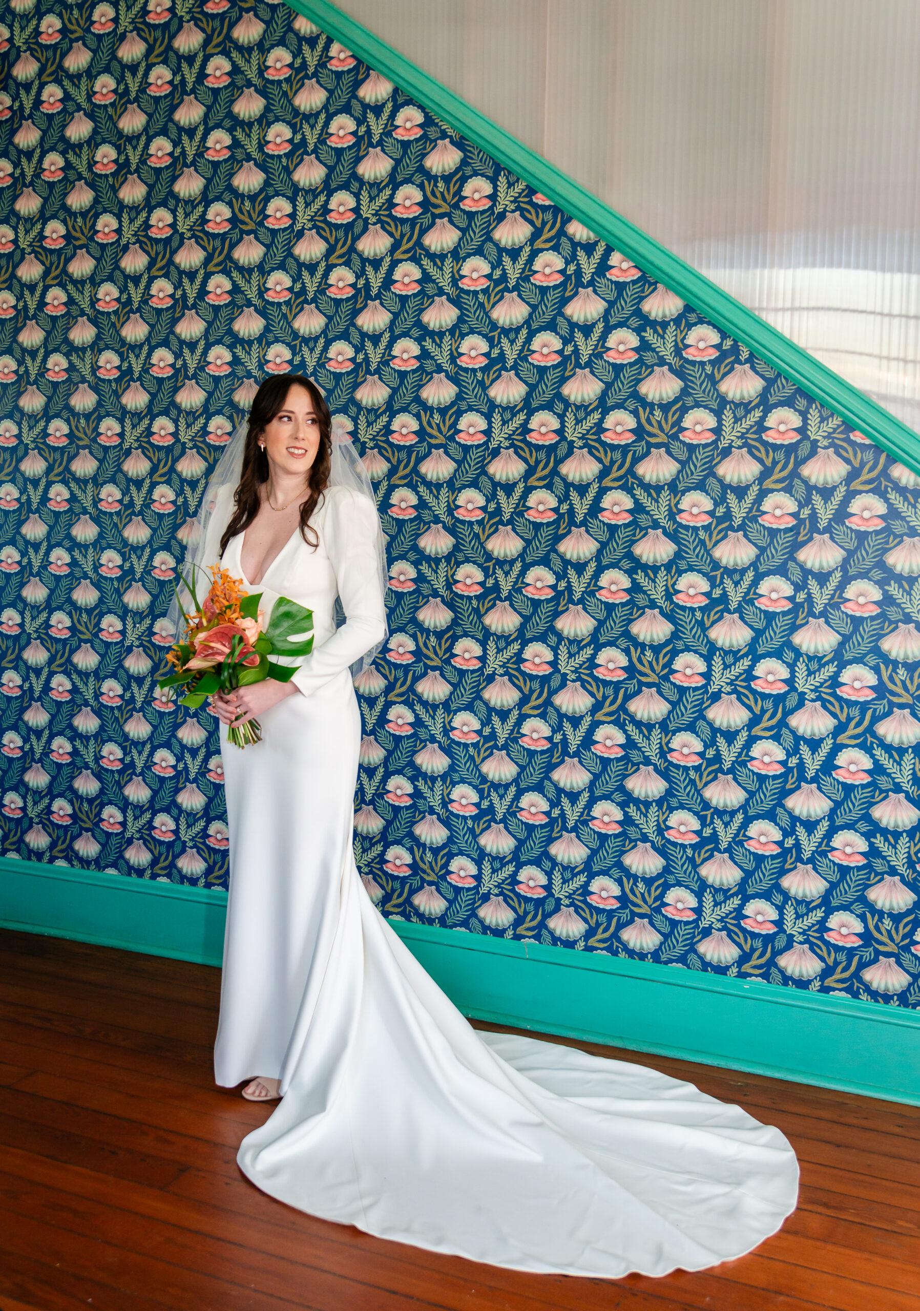 bride with tropical florals having a quiet moment on her elopement wedding day