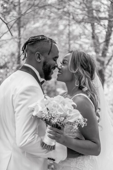 Bride and groom sharing a romantic moment with a bouquet during their New Orleans elopement.