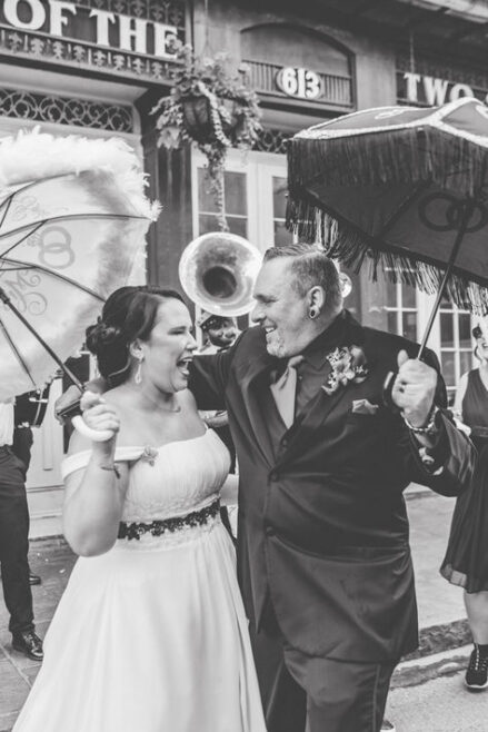 Couple celebrating with a second line parade after their New Orleans wedding.