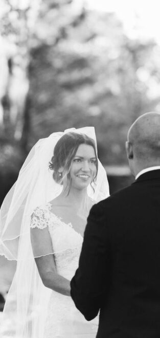 Bride and groom exchanging vows during an outdoor New Orleans wedding.