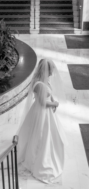 Bride standing in a grand venue during her New Orleans elopement.