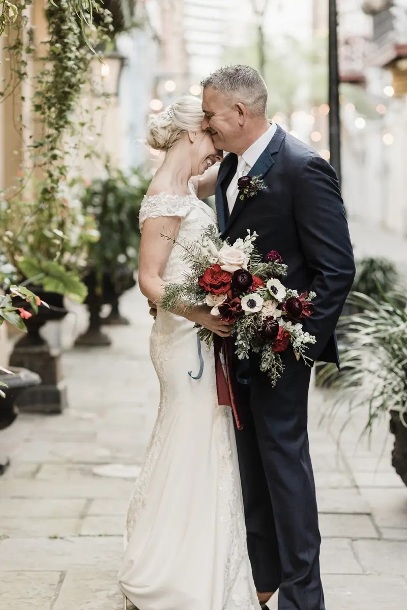 Couple sharing a moment during their elopement in the French Quarter, with colorful historic buildings around them