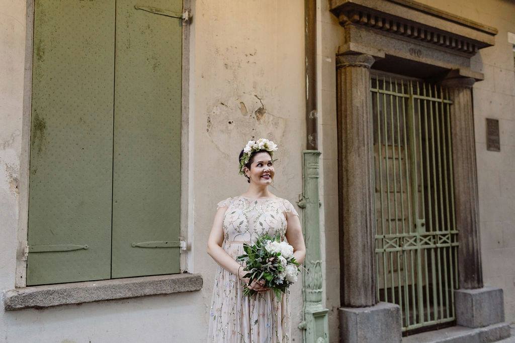 bride posing after her elopement in pirates alley New Orleans