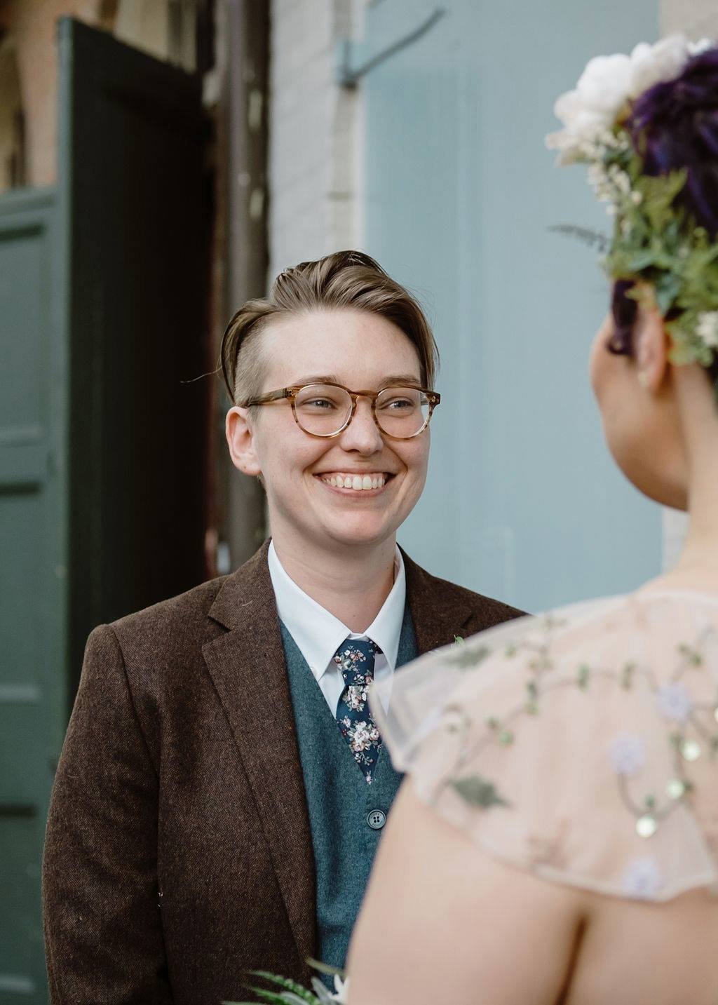 bride lovingly looking at her bride as they exchange vows in pirates alley new Orleans