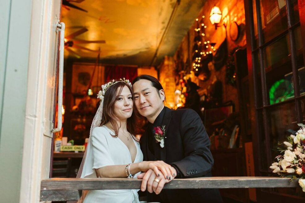Newlywed couple sharing a quiet moment at Pirate’s Alley bar in the French Quarter after their elopement.