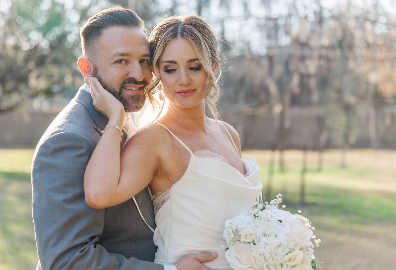 Newlyweds stand beneath the Tree of Life in New Orleans