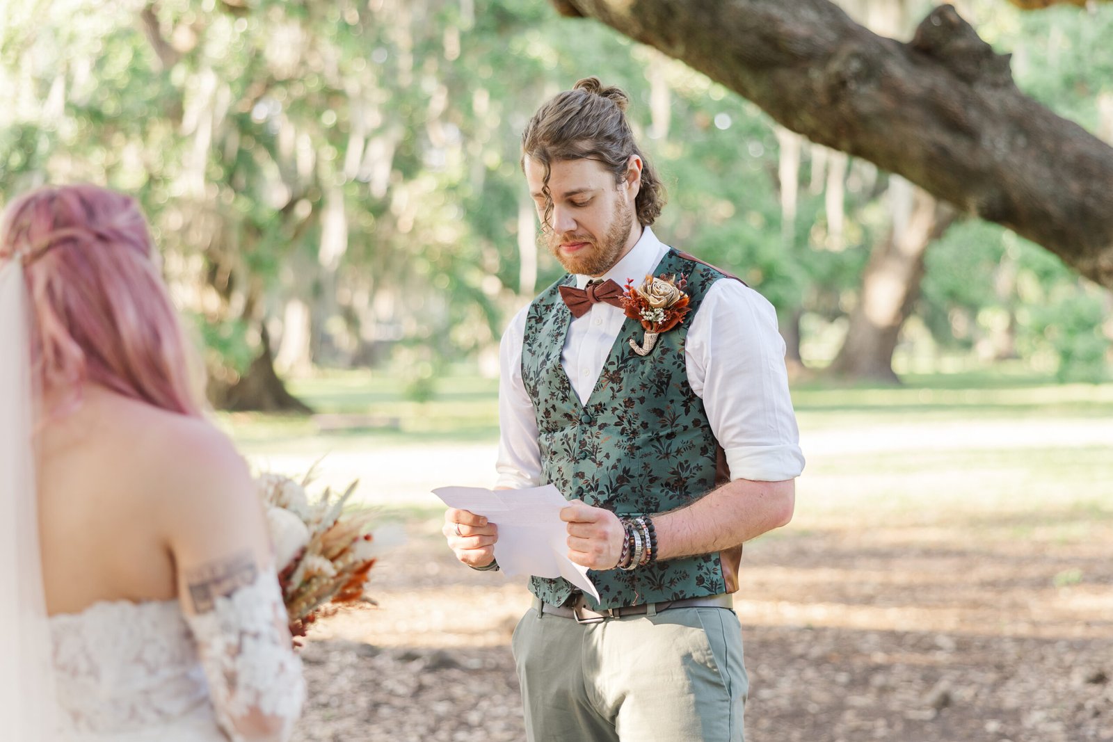 Couple exchanging vows under historic oak tree