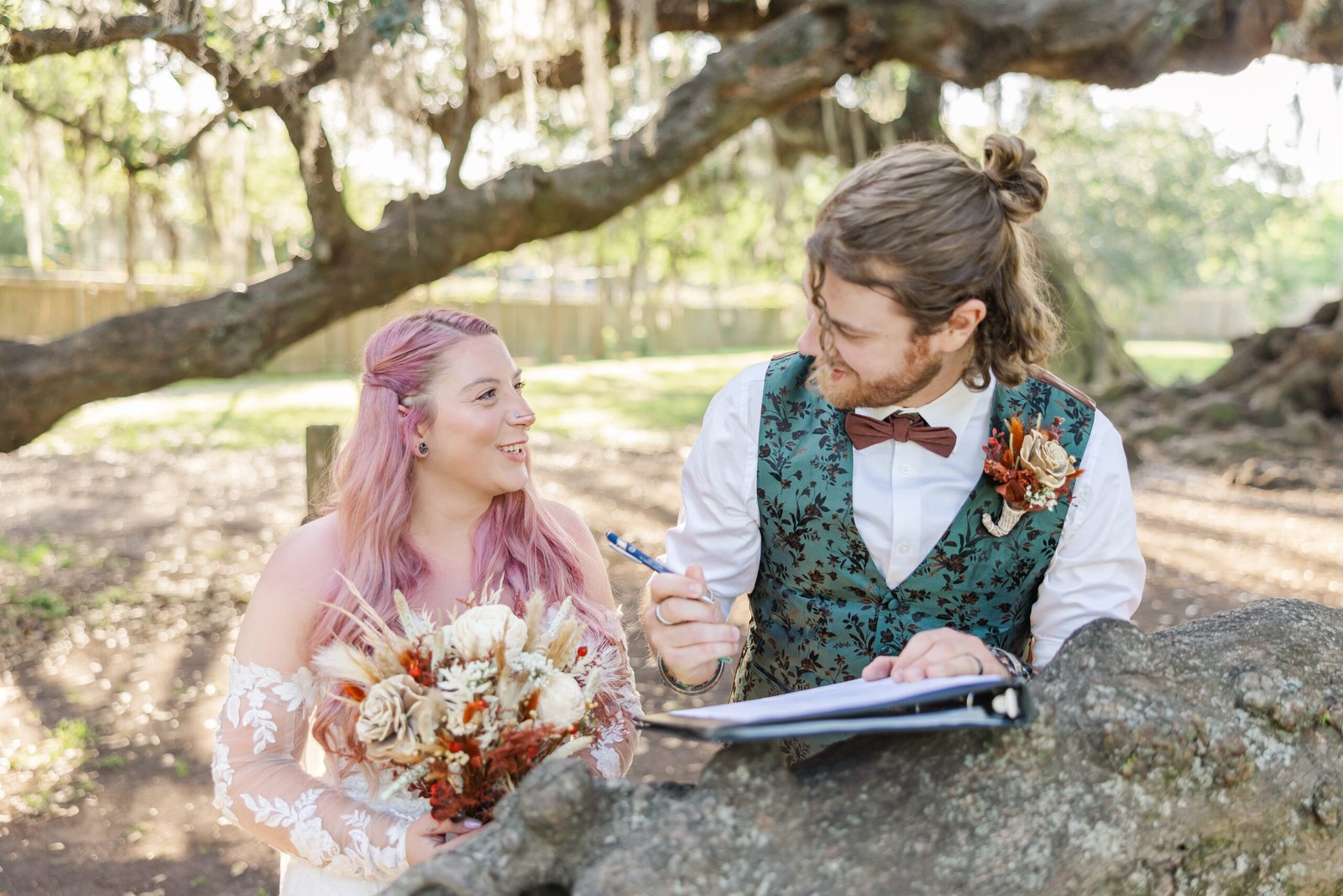 Bride and groom beneath ancient oak at Tree of Life