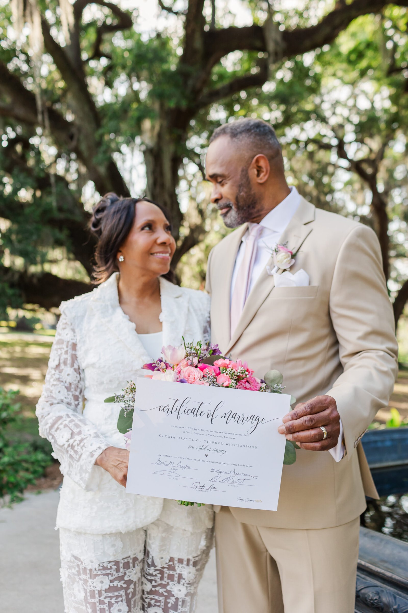 eloped couple posing with marriage license at butler fountain in city park New Orleans