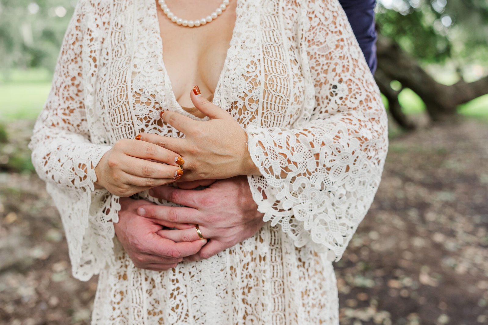 Couple shares moment admiring their rings after eloping at the Tree of Life