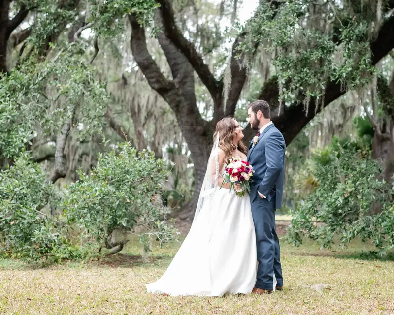 Bride and groom wedding portrait under oak tree in New Orleans City Park