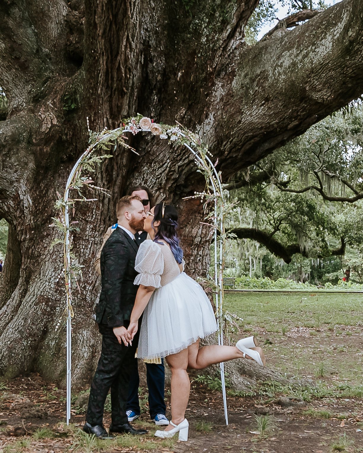 Couple sharing a fist kiss in City Park for their elopement in New Orleans