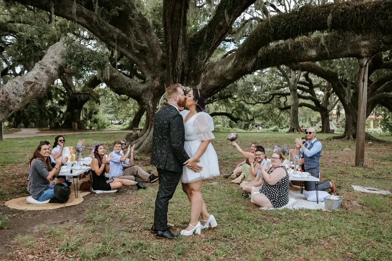 Couple posing after ceremony near cobblestone bridge