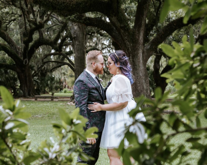 Newlyweds standing still in quiet City Park setting