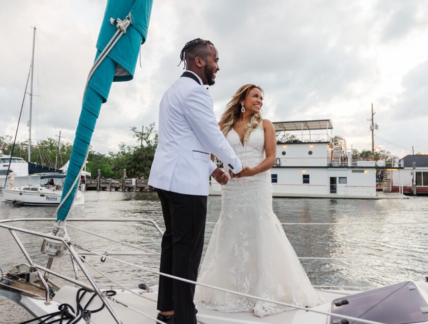 Newlyweds embracing on the deck of a sailboat during their New Orleans elopement