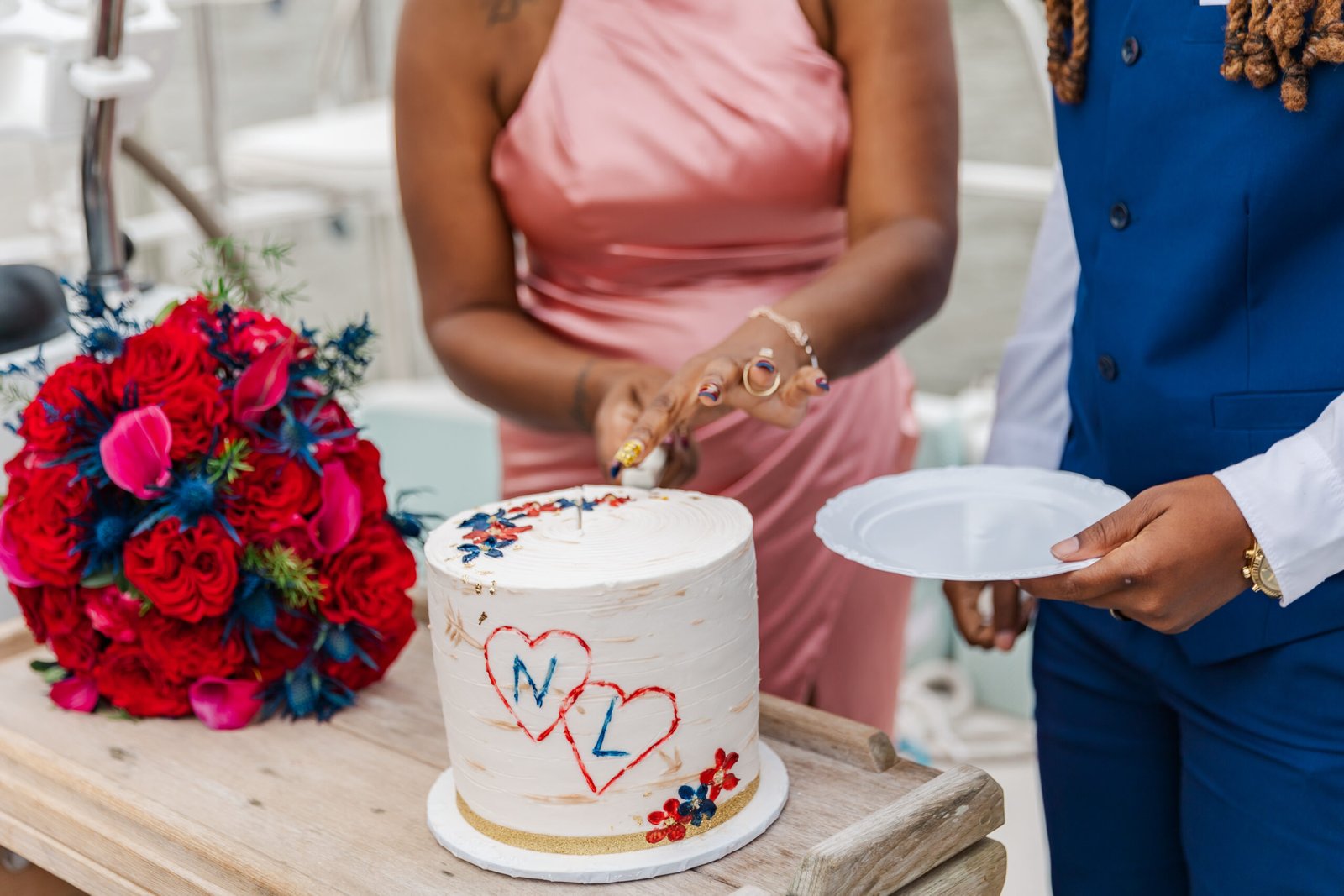 Eloping couple sharing their wedding cake on a sailboat in New Orleans