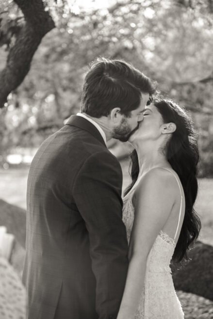 Couple sharing a quiet kiss under an oak tree, part of one of our New Orleans elopement packages in the Garden District
