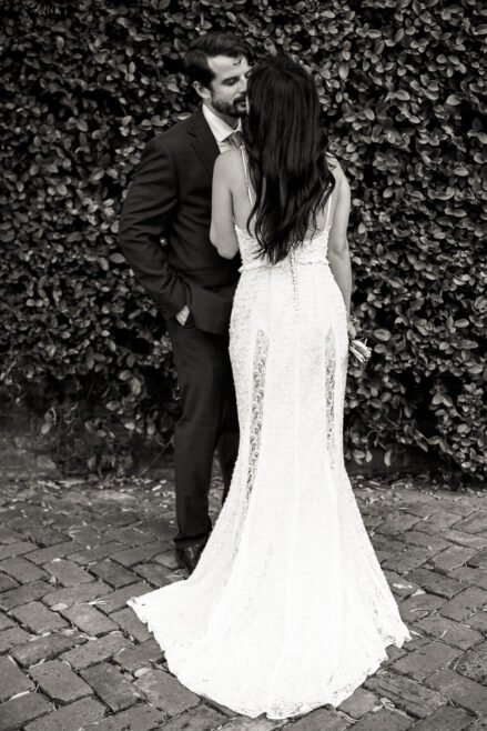 Bride and groom walking past historic mansions as part of their New Orleans elopement package experience