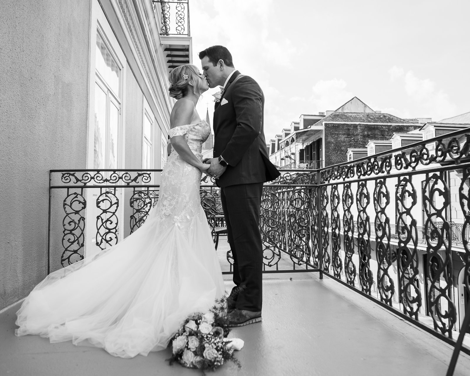 Bride and groom embracing in French Quarter New Orleans
