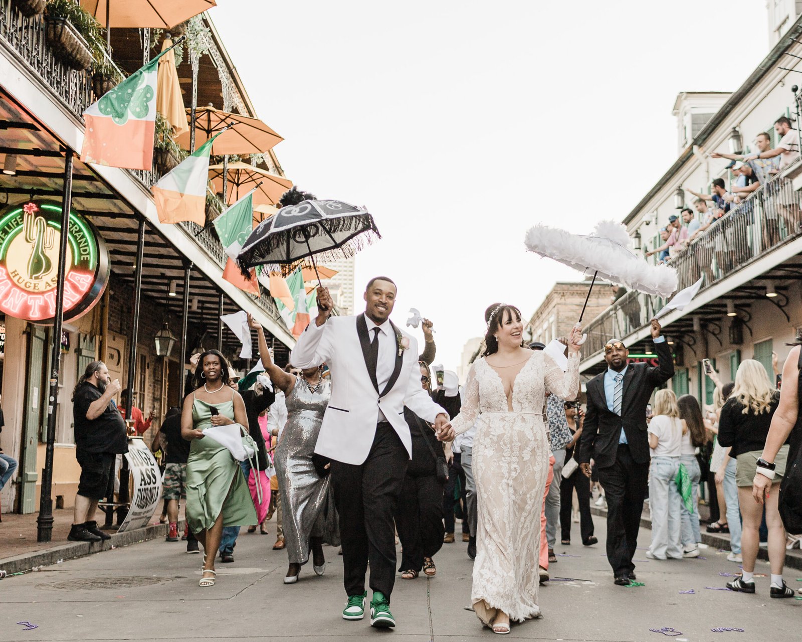 Eloped couple dancing in the streets during a New Orleans second line parade.