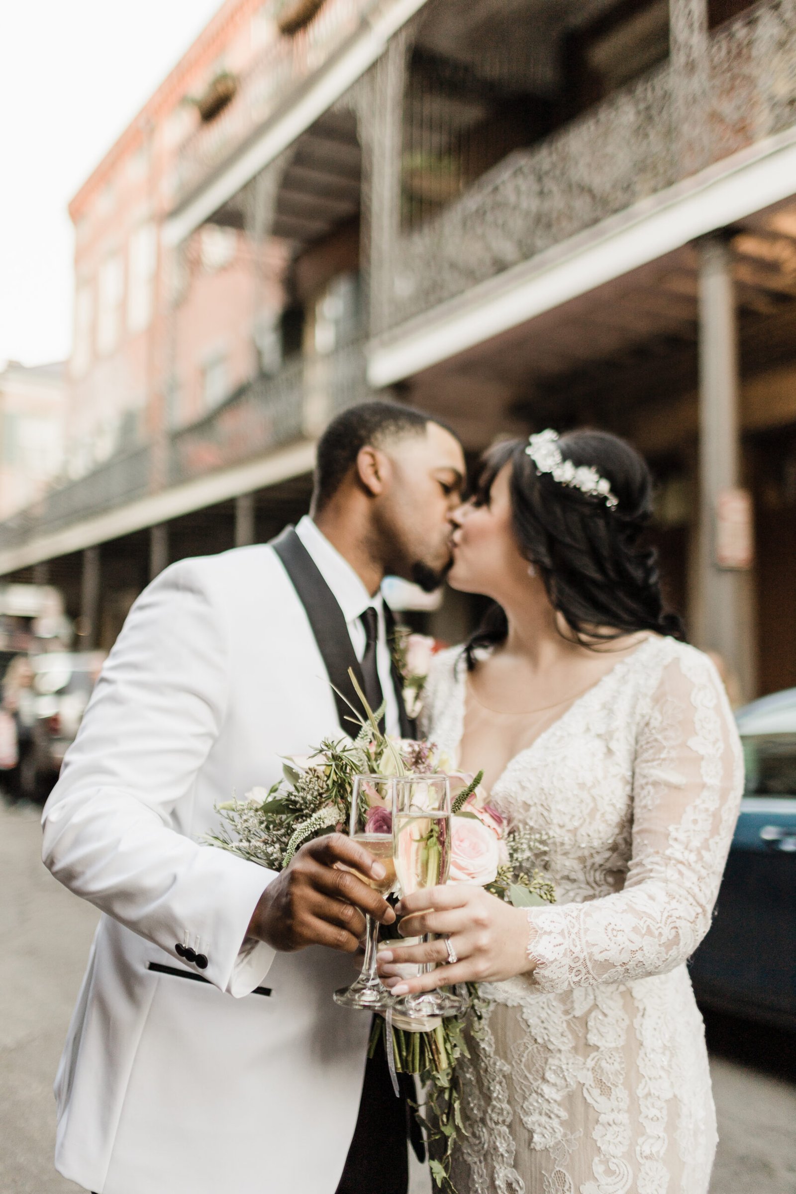 Eloped couple toasting with champagne in the French Quarter after their New Orleans wedding.