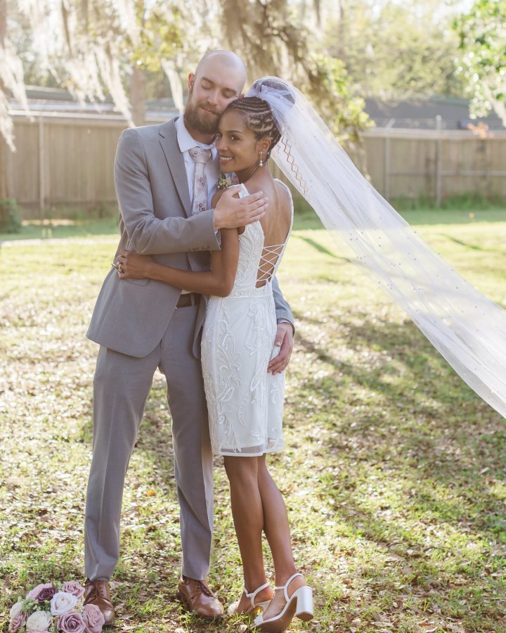 New Orleans elopement couple posing against the massive roots and trunk of the historic Tree of Life in Audubon Park.
